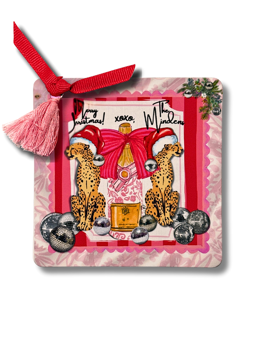 Decorative Christmas card with cheetahs, champagne bottle, and festive elements on a white background.